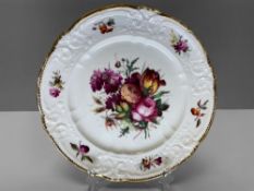 A NANTGARW PORCELAIN LONDON DECORATED PLATE having a border moulded with c-scrolls, ribbons and
