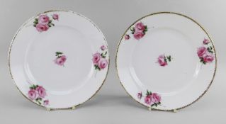 A PAIR OF NANTGARW PORCELAIN PLATES of circular form, finely painted with four sprigs of pink open