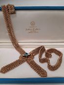 9CT GOLD BLUE TOPAZ & DIAMOND SET CROSSOVER NECKLACE of articulated design, the central topaz (0.8 x