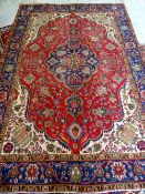 TABRIZ RUG, indigo medallion with pendants on a red floral field, ivory willow tree spandrels,