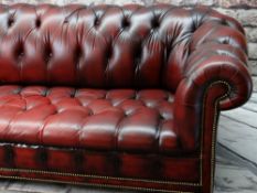 VICTORIAN-STYLE LEATHER CHESTERFIELD SOFA, red button upholstered and close nailed on turned feet,