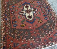BAKHTIAR RUG, pointed ivory medallion on a soft red and sage green field, cherry border and ivory