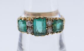 18CT GOLD DIAMOND & EMERALD RING the central emerald 7 x 5mms, ring size P, 5.0gms, in red square