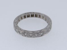 18CT WHITE GOLD HALF ETERNITY RING set with ten diamonds and overall engraved, ring size O, 4.5 gms,