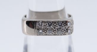 18CT WHITE GOLD DIAMOND SET RING set with eight diamonds, ring size N, 6.3gms, in black square
