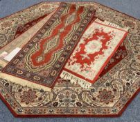 THREE EASTERN STYLE CARPETS all red ground with traditional and floral patterns including an