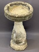 RECONSTITUTED STONE BIRD BATH, the 38cms diameter top on a bulbous column base, 69cms H