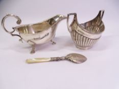 HALLMARKED SILVER, THREE ITEMS to include a three footed sauce boat with scroll handle, Sheffield