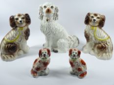 STAFFORDSHIRE COMFORTER DOGS, A PAIR - red and white with flower baskets in mouths, 16cms tall and