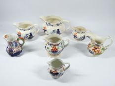 GAUDY WELSH GRADUATED SET OF THREE OCTAGONAL JUGS, 15cms tall, and an assortment of other Gaudy