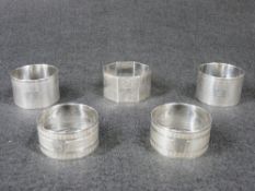 NAPKIN RINGS - 1. A pair of sterling silver engine turned wide rings, each with a small initial, 1.