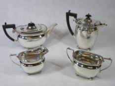 A FOUR PIECE SILVER TEA & COFFEE SERVICE - each piece of oval plain form with four ball supports and