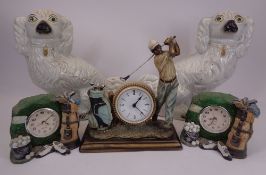 WHITE STAFFORDSHIRE COMFORTER DOGS, A PAIR and three golfing interest composition clocks