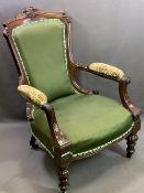 EDWARDIAN MAHOGANY GENTLEMAN'S UPHOLSTERED ELBOW CHAIR - on turned feet with carved detail, 96cms H,