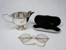 SILVER PEDESTAL CREAM JUG - Sheffield 1957, maker Walker & Hall, 4 troy ozs and a pair of gilt