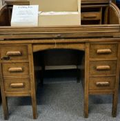 CIRCA 1900 OAK ROLL TOP DESK and a boxed ceiling fan, the desk tambour requiring restoration, 107cms
