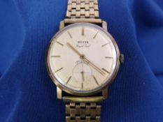 A GENT'S HEFIK CIRCULAR DIAL 9CT GOLD WRISTWATCH - with 9ct seven row bracelet strap, 38grms gross