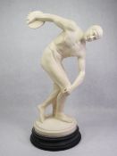 A CIRCULAR BASED COMPOSITION FIGURINE entitled 'Discobolo', 40cms H