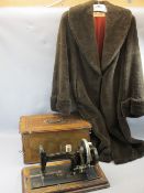 VINTAGE HAND CRANK SEWING MACHINE and a faux fur full length lady's coat, the sewing machine in a