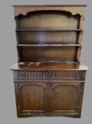 LINENFOLD STYLE DRESSER - a two shelf rack and a two drawer over two door base, 178cms H, 121cms