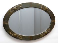 ARTS & CRAFTS-STYLE METAL FRAMED OVAL WALL MIRROR, embossed fruit and leaves to the sides, bevel