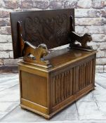 REPRODUCTION OAK MONK'S BENCH with lion arm supports, shield carved top and linen fold front, 106cms