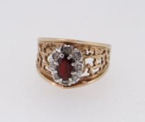9CT GOLD GARNET & DIAMOND CLUSTER RING of openwork design, ring size L / M, 4.5gms