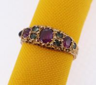 15CT GOLD EMERALD & GARNET RING, scroll engraved, ring size K, 2.1gms, in square cream ring box