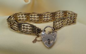9CT GOLD GATE BRACELET, of barley twist design with heart shaped padlock, 20.5gms