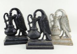 THREE SIMILAR 'STORK AND EWER' CAST IRON DOOR STOPS, 28cms high each (3)