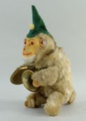 MAX CARL CLOCKWORK MUSICAL MONKEY, wearing cloth cap, printed card label in ear, 19cms high