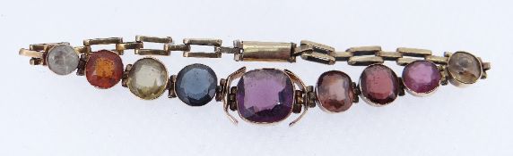 YELLOW METAL MULTI-GEM BRACELET featuring nine graduated gem stones, 17.5cms long, 6.9gms