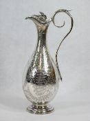 SILVER WINE FLAGON - on a circular step base, narrow neck, hinged lid, scrolled handle and all