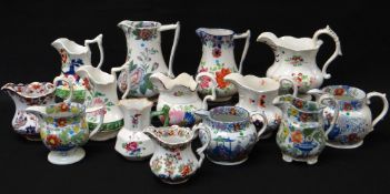 COLLECTION OF FOURTEEN COLOURFUL WELSH POTTERY JUGS painted and transfer decorated, Llanelly and