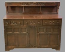 PRIORY OAK STYLE BUFFET SIDEBOARD having three frieze drawers and twin lower cupboard doors, all