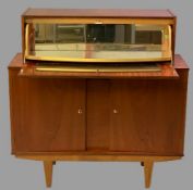 MID-CENTURY TEAK COCKTAIL CABINET with drop down top section and mirrored interior over twin opening