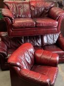 THREE PIECE LOUNGE SUITE in red leather effect upholstery, comprising three seater couch, 82cms H,
