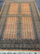 EASTERN STYLE WOOLLEN CARPET - rust ground with repeating central block and traditional patterned