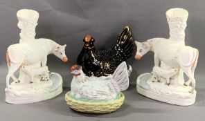 STAFFORDSHIRE - a pair of cow spillholders, 29cms H and two hens on nests