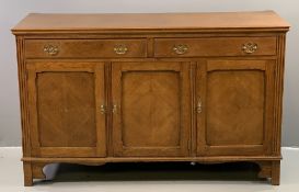 OAK SIDEBOARD BASE with three fielded panel cupboard doors and two drawers above with brass drop