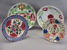 FOUR ANTIQUE SPONGEWARE CIRCULAR SHALLOW DISHES, colourfully floral decorated, two in the manner