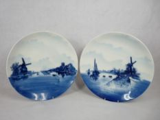 ROSENTHAL BLUE & WHITE DELFT WALL CHARGERS, A PAIR - typically decorated Dutch scenes with