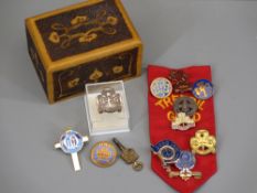 GIRL GUIDES BADGES - a collection in a pokerwork wooden box and a vintage pocket watch key