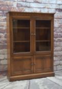 ERCOL ELM BOOKCASE, with glazed cupboard above panelled doors, 137.5h x 101w x 29cms