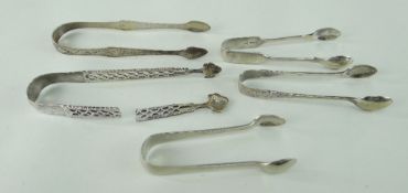 FOUR SILVER SUGAR TONGS comprising two engraved examples, probably 18th century, small Walker & Hall