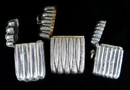 THREE SIMILAR SILVER VESTA CASES of reeded form, Birmingham & London hallmarks, 62.5gms overall (