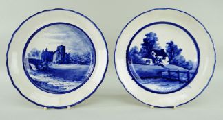 A PAIR OF LLANELLY POTTERY PLATES painted in underglaze blue with a church or abbey and with a