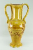 A EWENNY POTTERY AMPHORA SHAPED FLOOR VASE with twin handles and spreading circular foot, yellow