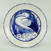LLANELLY POTTERY PLATE with crimped rim, painted with a standing heron or stork amongst reeds,