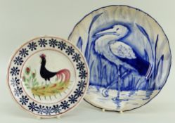 A LLANELLY POTTERY PLATE PAINTED IN BLUE WITH STORK IN REEDS of lobed form, 25cms diam, together